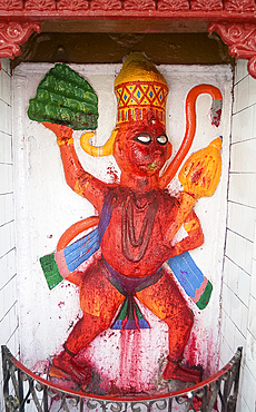 Temple shrine to Hanuman, the monkey god, daubed by pilgrims with red powder, at the entrance to Sri Mahabhairab Mandir, Tezpur, Assam, India, Asia