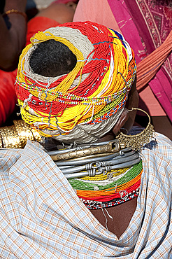 Head of Bonda tribeswoman wearing traditional beaded cap held with metal clips, large earrings and metal and bead necklaces, Rayagader, Orissa, India, Asia