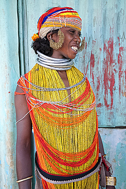 Bonda tribeswoman wearing traditional bead costume with beaded cap, large earrings and metal necklaces at weekly market, Rayagader, Orissa, India, Asia