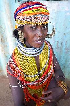 Bonda tribeswoman wearing traditional bead costume with beaded cap, large earrings and metal necklaces at weekly market, Rayagader, Orissa, India, Asia