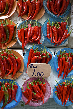 Colourful red chillies on blue plates on a market stall in Kuching, Sarawak, Malaysian Borneo, Malaysia, Southeast Asia, Asia