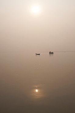 Fishing boat and river ferry on the River Ganges in the early morning, Sonepur, Bihar, India, Asia