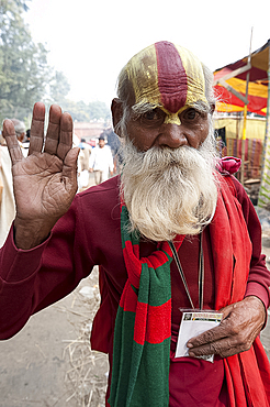 Vaishnavite pundit dressed in red and with heavy sandalwood and abir tilak on his forehead, at Sonepur Cattle Fair, Bihar, India, Asia