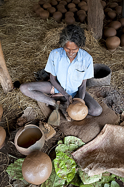 Potter making clay water pots in a thatched shelter in a rural village, near Rayagada, Orissa, India, Asia