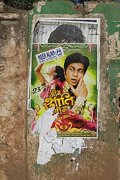 Shahruk Khan in torn Bollywood movie poster on wall, Hospet, Karnataka, India, Asia