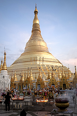 Candles placed by devotees at sunset in front of the golden Shwesagon Pagoda, a 2500 year old Buddhist pilgrimage site, Yangon, Myanmar (Burma), Asia