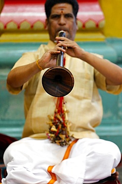 Musician playing a Nadaswaram, a traditional Indian wind instrument, Sri Mahamariamman Hindu Temple, Kuala Lumpur. Malaysia, Southeast Asia, Asia