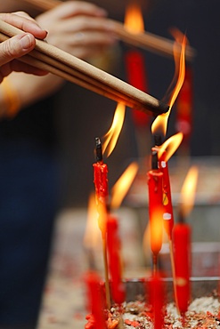 Chinese man burning incense and praying to a prosperous future, Guan Di Chinese Taoist Temple, Kuala Lumpur, Malaysia, Southeast Asia, Asia