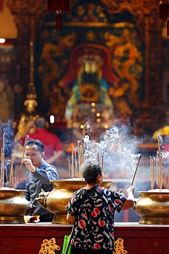 Chinese man burning incense and praying to a prosperous future, Guan Di Chinese Taoist Temple, Kuala Lumpur, Malaysia, Southeast Asia, Asia