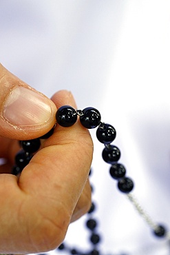 Close-up of hands of Dominican nun praying the rosary beads, Vietnam, Indochina, Southeast Asia, Asia