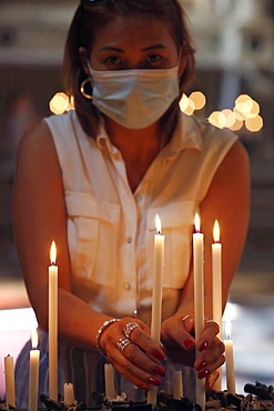 Woman with face mask praying in church during coronavirus epidemic, Venice, Veneto, Italy, Europe