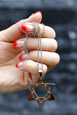 Close up on hands of woman with a Star of David (Jewish Star) pendant, Vietnam, Indochina, Southeast Asia, Asia