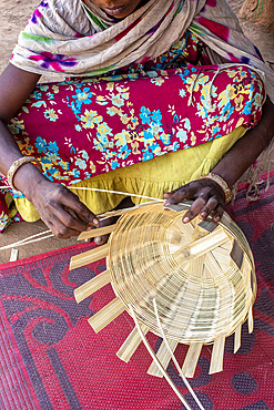 Adivasi woman making baskets in a village in Narmada district, Gujarat, India, Asia