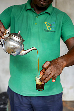 Man pouring tea in Kaolack, Senegal, West Africa, Africa