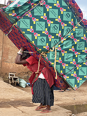 Woman carrying a huge load on her head and back in Bukavu, Democratic Republic of the Congo (Congo) (DRC), Africa