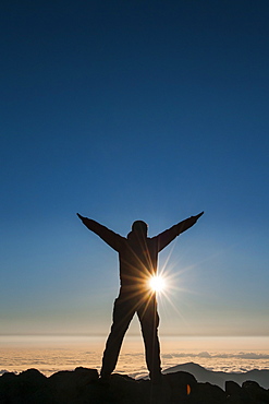 Tourist in backlight waiting for sunset on top of Haleakala National Park, Maui, Hawaii, United States of America, Pacific