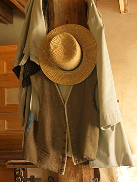 Old straw hat and vest hanging on a wooden post, Upper Canada Village, Morrisburg, Ontario, Canada, North America