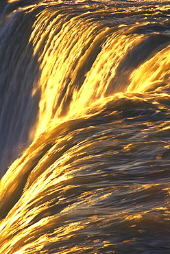 Close-up of waterfalls with golden sunlight highlighting the water, Niagara Falls, Ontario, Canada, North America