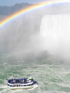 Maid of the Mist tour boat approaching the Canadian Falls with a rainbow, Niagara Falls, Ontario, Canada, North America