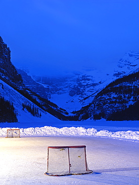 Ice rink with hockey nets on frozen Lake Louise at dawn, Banff National Park, Alberta, Canada, North America