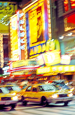 Times Square illuminated at night with yellow taxis, New York, United States of America, North America