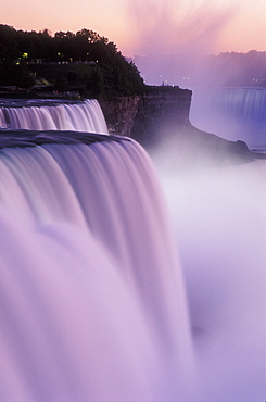 American Falls at dusk illuminated with colored lights, Niagara Falls, New York State, United States of America, North America