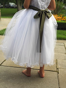 Detail of dress of a flower girl at a wedding