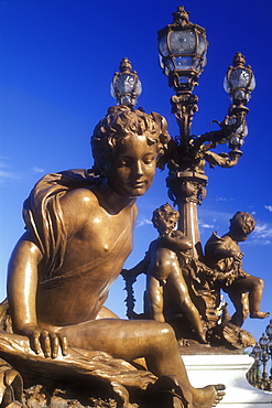 Bronze cherub statues and lamp posts adorning bridge, Pont Alexandre III, Paris, France, Europe