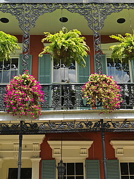 Colorful French Quarter residential street with wrought iron balconies and hanging flower baskets, New Orleans, Louisiana, United States of America, North America