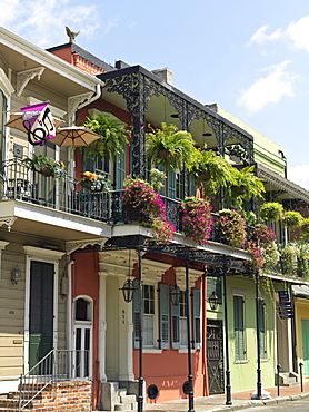 Colorful French Quarter residential street with wrought iron balconies and hanging flower baskets, New Orleans, Louisiana, United States of America, North America