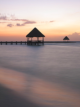 Pier with palapa jutting out into the water from the beach at sunrise, Mayan Riviera, Akumal, Yucatan, Quintana Roo, Mexico, North America