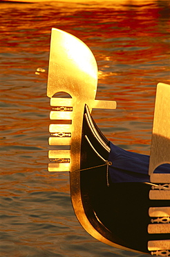 Bow of gondola illuminated at sunset, Venice, Veneto, Italy, Europe