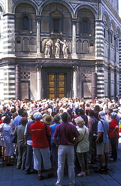 Group of tourists viewing the doors of the Baptistry, Florence, Tuscany, Italy, Europe