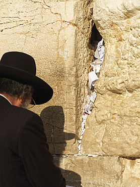 Western Wall (Wailing Wall) with worshipper and prayer slips, Jerusalem, Israel, Middle East