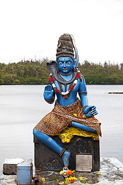 Statue of Vishnu, the Hindu god with cobra and wearing a leopardskin, in human form as Krishna, at Ganga Talao, Mauritius, Indian Ocean, Africa