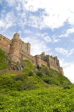 Bamburgh Castle, a hilltop fortress constructed on top of a craggy outcrop of volcanic dolerite, Grade I Listed Building, Bamburgh, Northumberland, England, United Kingdom, Europe