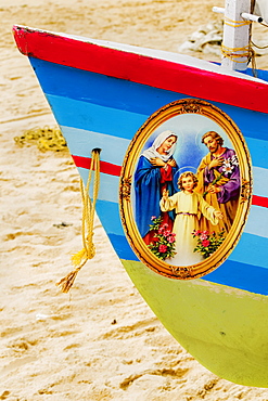 Colourful prow of fishing boat with Jesus, Mary, Joseph Christian picture on Marari Beach, Mararikulam, Alappuzha, Kerala, India, Asia