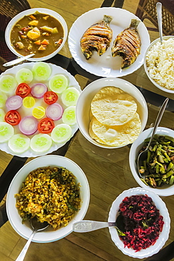 Typical Keralan meal on backwater houseboat, rice, beans, cabbage, curry, papad, fried fish, Alappuzha (Alleppey), Kerala, India, Asia