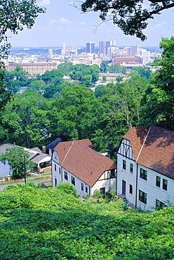 Houses amid trees and city skyline in the background, of Birmingham, a former premier steel producer and Civil Rights centre, Alabama, USA