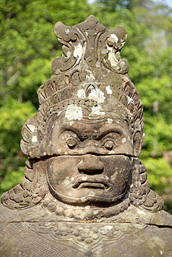 Portrait face of a Khmer stone figure at South Gate Angkor Thom Siem Reap Cambodia