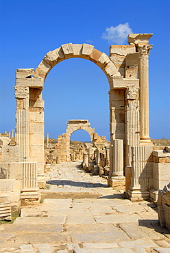 Two arches overstretch old Roman street cardo Leptis Magna Libya