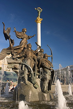 Ukraine Kiev Place of Independence memorial of the founder of the city of Kiev sovereigns Kyj, Scek, Chryv and their sister LybidÂ´ memorial in bronze shining water fountain blue sky historical memorial column of Independence 2004