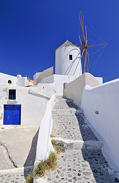 Paved path to a windmill in Oia, Ia, Santorini, Cyclades, Greece, Europe