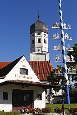 Village smithy, church and maypole in Erling, Andechs municipality, Fuenfseenland, Upper Bavaria, Germany, Europe