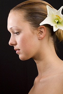 Young woman, lily in her hair