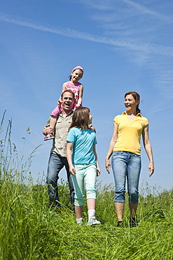 Family walking relaxed in a flower meadow