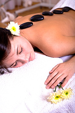 Patient in a physiotherapy practice getting a Hot Stone Massage