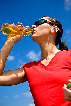 Young woman drinking after a run