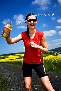 Young woman drinking after a run