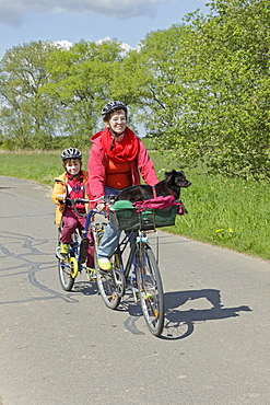 Mother and son with their dog on a cycling tour